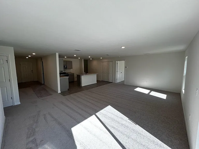 View from rear of home of kitchen, door to master bedroom