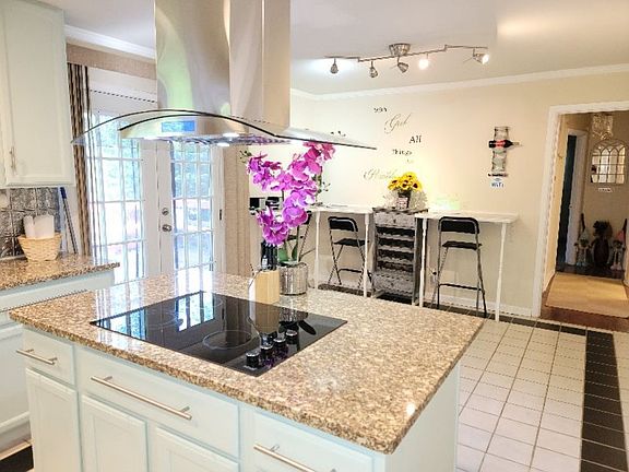 First floor kitchen granite counter tops double doors leading to large deck.