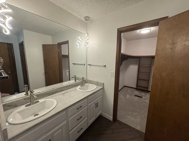 Master bathroom w/ double sinks and large walk-in closet