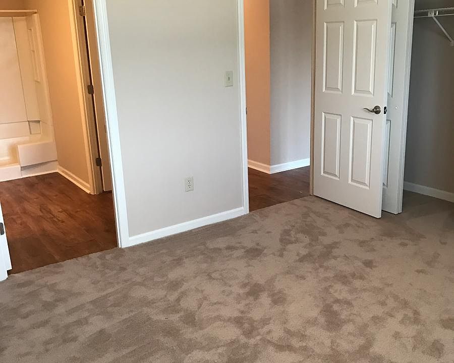 Bedroom with wall length closet and ceiling fan
