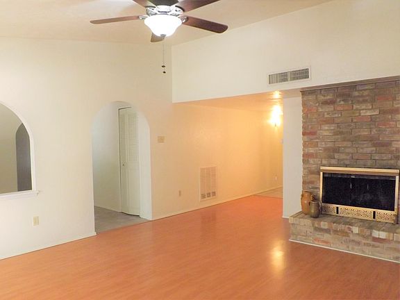 Spacious living area with ceiling fan