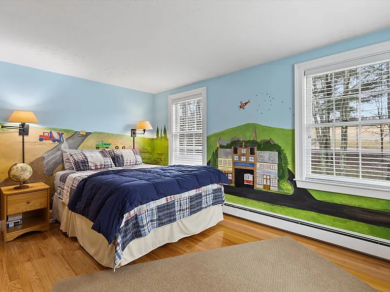 Guest bedroom 3 with queen bed and children's mural.