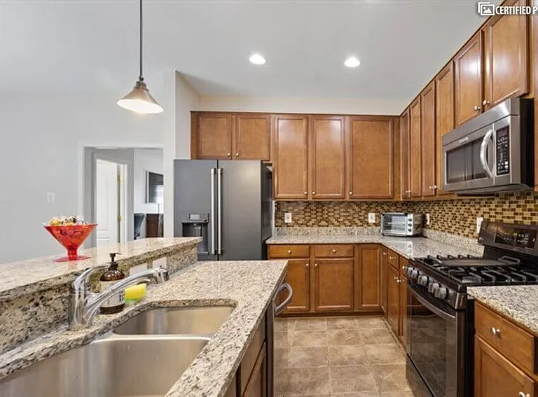 Kitchen with granite countertops and newer appliances.