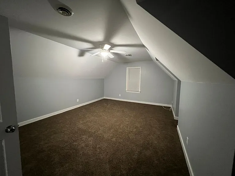 Bedroom 3 photos, window shown faces side of the home