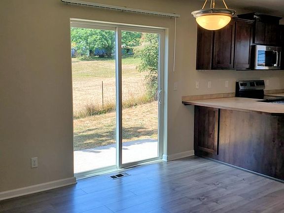 Dining room with slider to back concrete patio