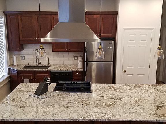 Gas range with hood that vents to exterior