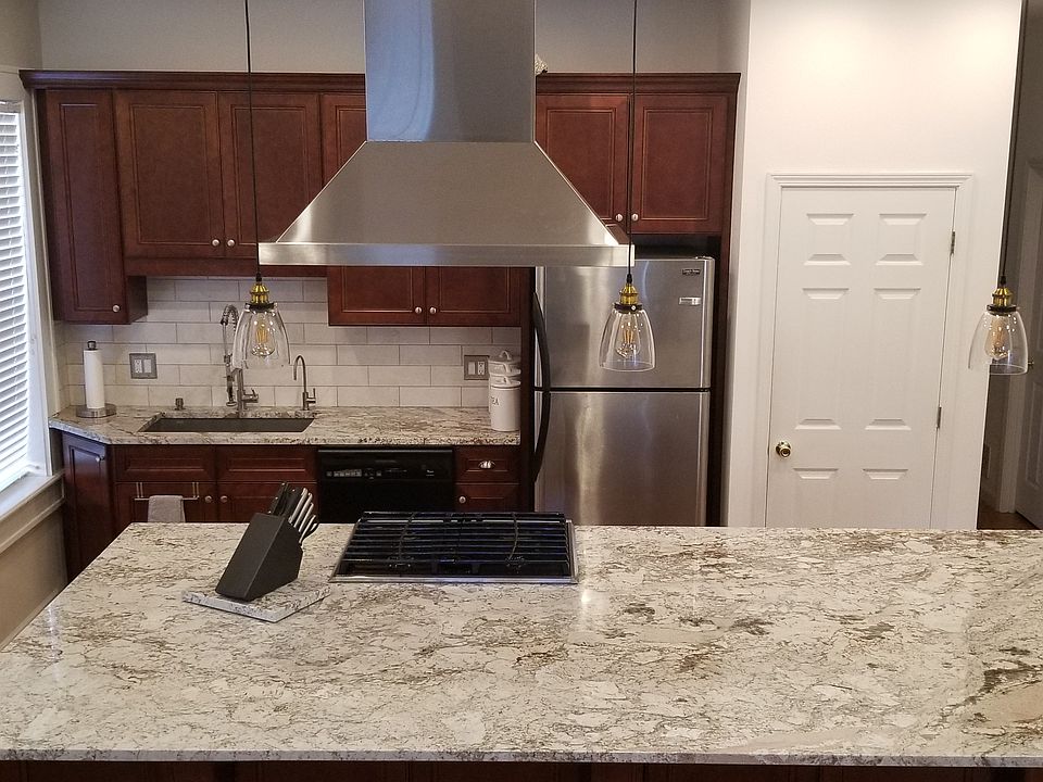 Gas range with hood that vents to exterior