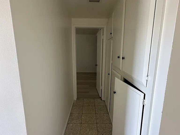 First bedroom off of the front door with lots of storage and long hallway