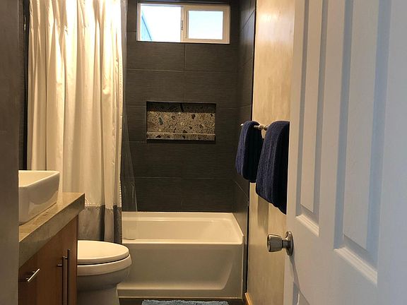 Custom concrete counters, basalt tile, cedar cabinetry and imperial plaster full bath.