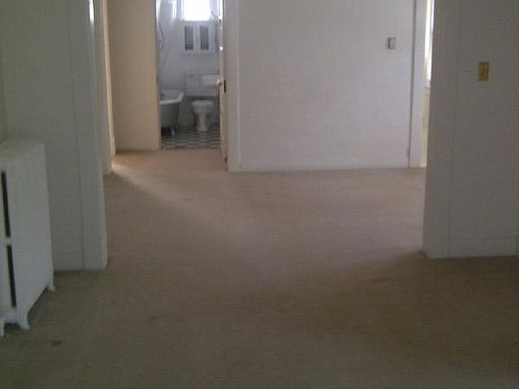 view from front door past front bedroom/office through living room, dining room past dressing room, master bedroom to bathroom