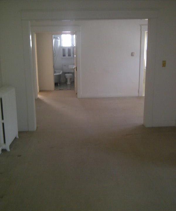 view from front door past front bedroom/office through living room, dining room past dressing room, master bedroom to bathroom