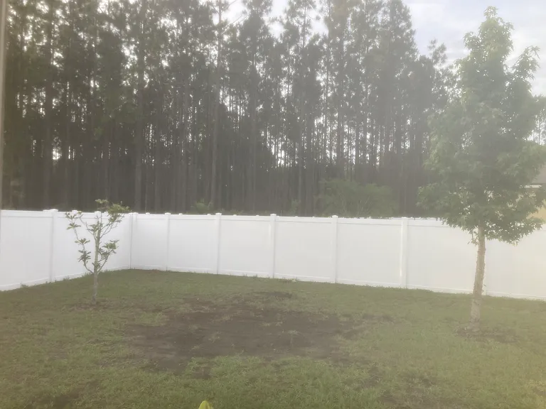The fenced backyard backs up to preserve