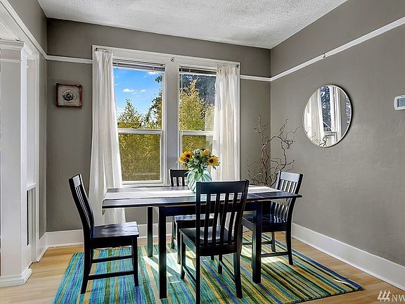 Formal dining room filled with light & nice bamboo screening for a private feel.