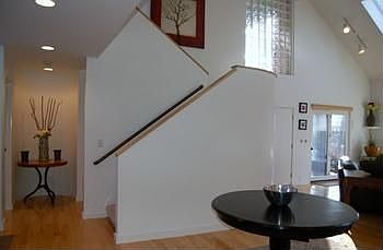 Stairway leading to upper level is light and bright with skylights.