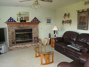 Step down into this nice size family room with wood burning fireplace.