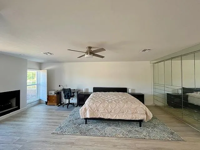 Master Bedroom with fireplace and adjustable electric stand up desk.