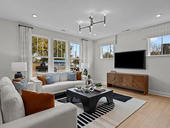 Family room with premium lighting and large windows in the Adaline Design new townhome in Charlotte,
