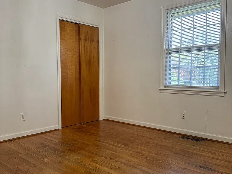 Another view of Bedroom #1 showing closet and window overlooking front yard.