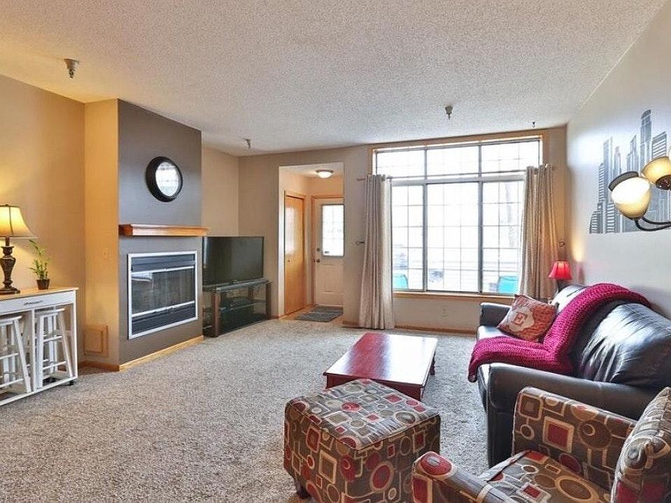 Large family room-light and bright with window overlooking patio in front of townhome