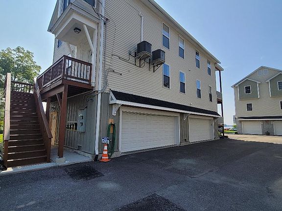 All new ground-level batten board siding, security cameras, and small roofs over the garage doors.