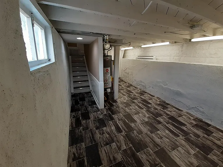 Well-lit basement Laundry room with extra storage.