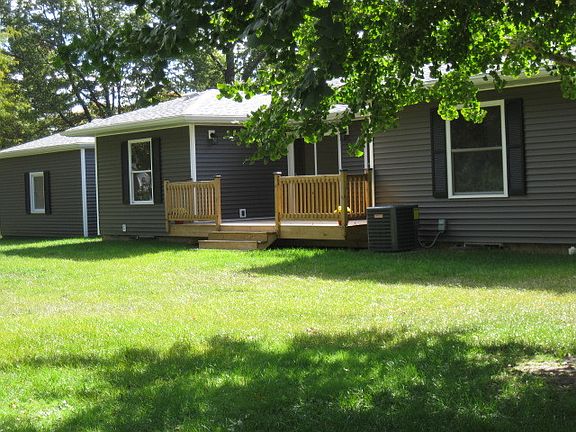 View of the back with attached Deck
						:
						This part of the back yard has a large tree that is very unique Note deck & AC