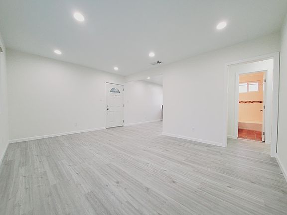 Living room looking to dining and kitchen