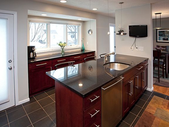 Slate tile floor, Bosch dishwasher, sliding shelves in cabinetry