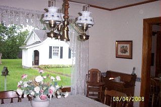 Formal dining room overlooks private yard and carriage house