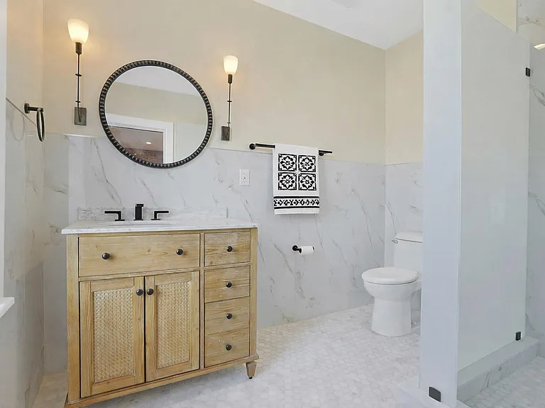Sun-filled European-style bathroom features towel warmer.