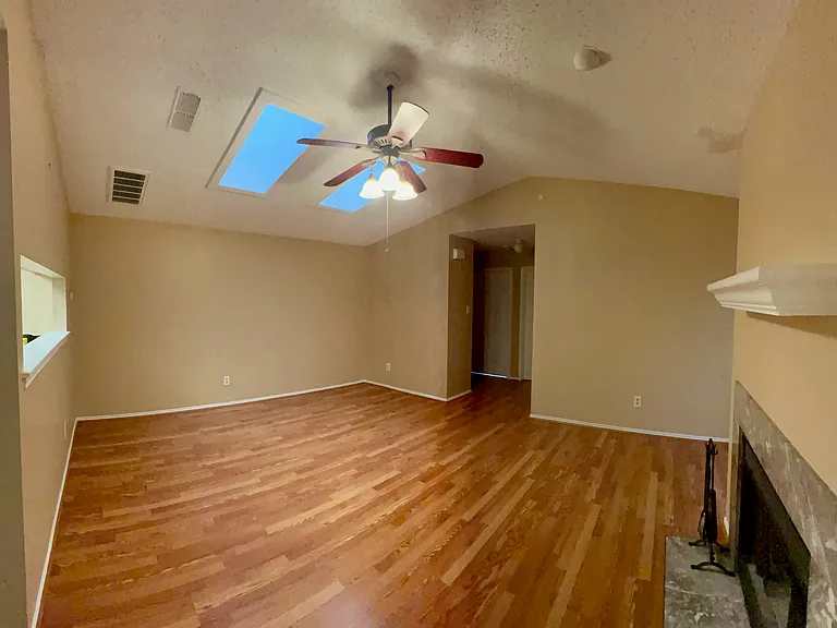 Living room separating the master bedroom on one side with the other two bedrooms on the other.