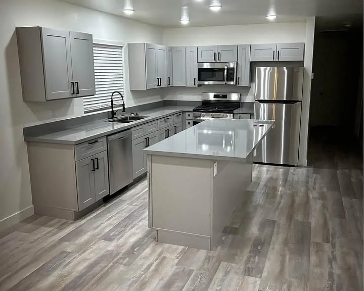 Kitchen and island with granite countertops and shaker style cabinets with soft close
