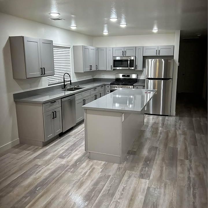Kitchen and island with granite countertops and shaker style cabinets with soft close