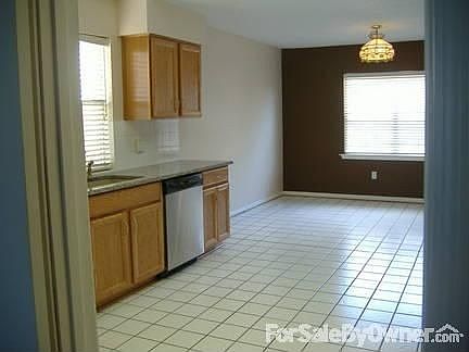 dining area at end of kitchen with view to back deck, rosebushes, fruit trees