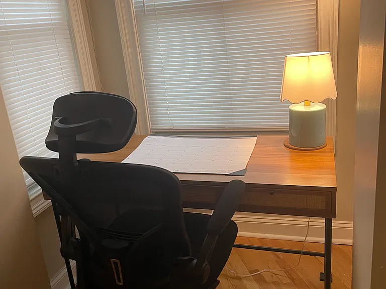 Desk and chair to the right of the kitchen.