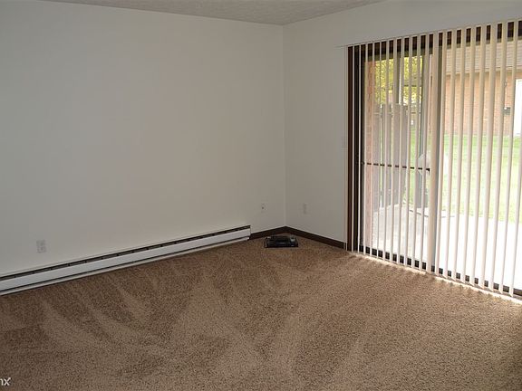 Spacious living room with plenty of natural sunlight that ra