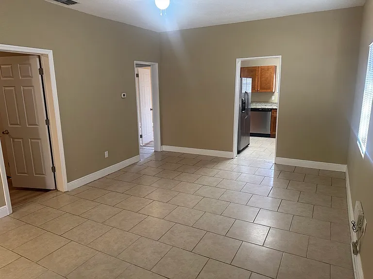 Main family/dining room, with doors to two bedrooms and kitchen.