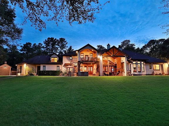 Rear exterior view at night featuring 75 Landscape and Security Lights throughout the property.
