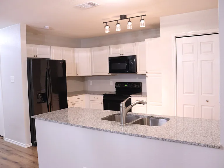 Open concept kitchen with fridge included.