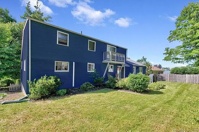 fully fenced in yard with a small raised deck