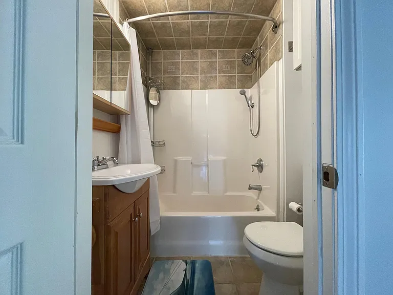 Bathroom one with tub/shower combo, towel warmer, and water pick massaging shower head and wand.