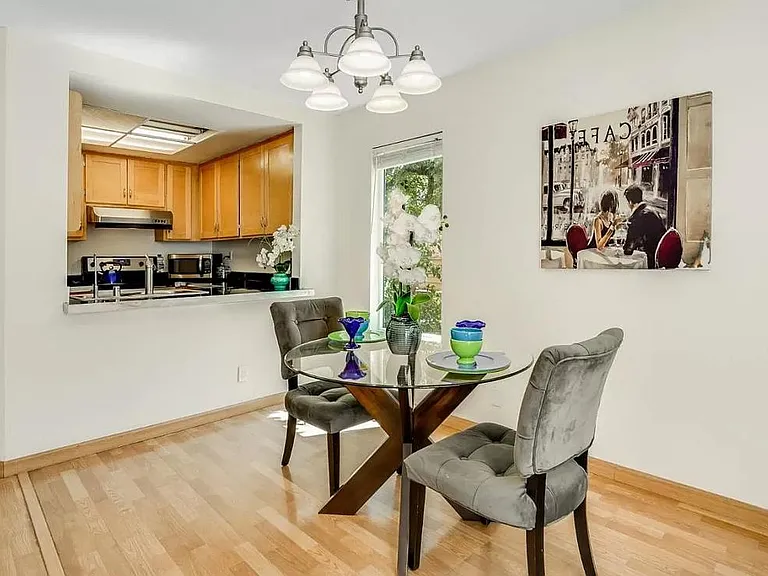 Lovely Spacious Dining room with Gleaming Wood Floors and Tree-Top Surround Views.
