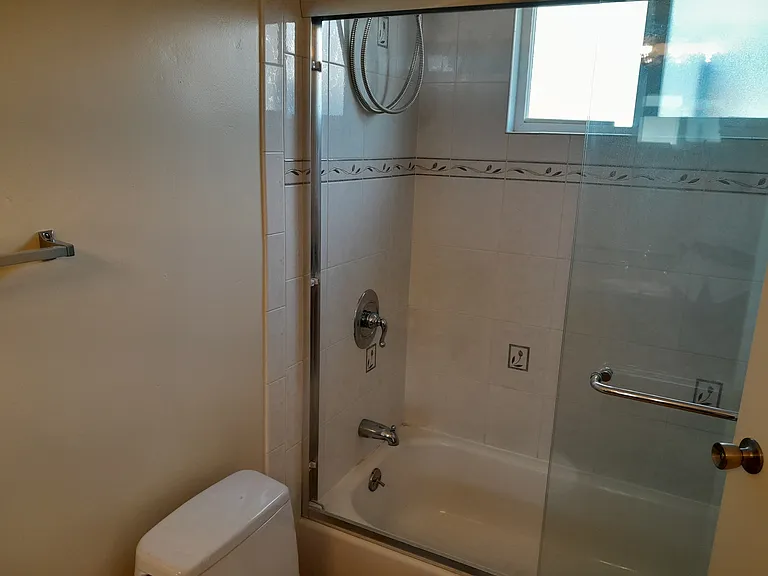 Master Bathroom with marble countertop, shower-tub combo, and tile floor