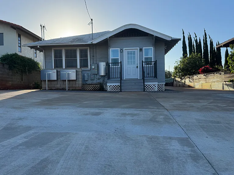 Front of house with parking for 4 vehicles and 2 Enphase solar batteries!