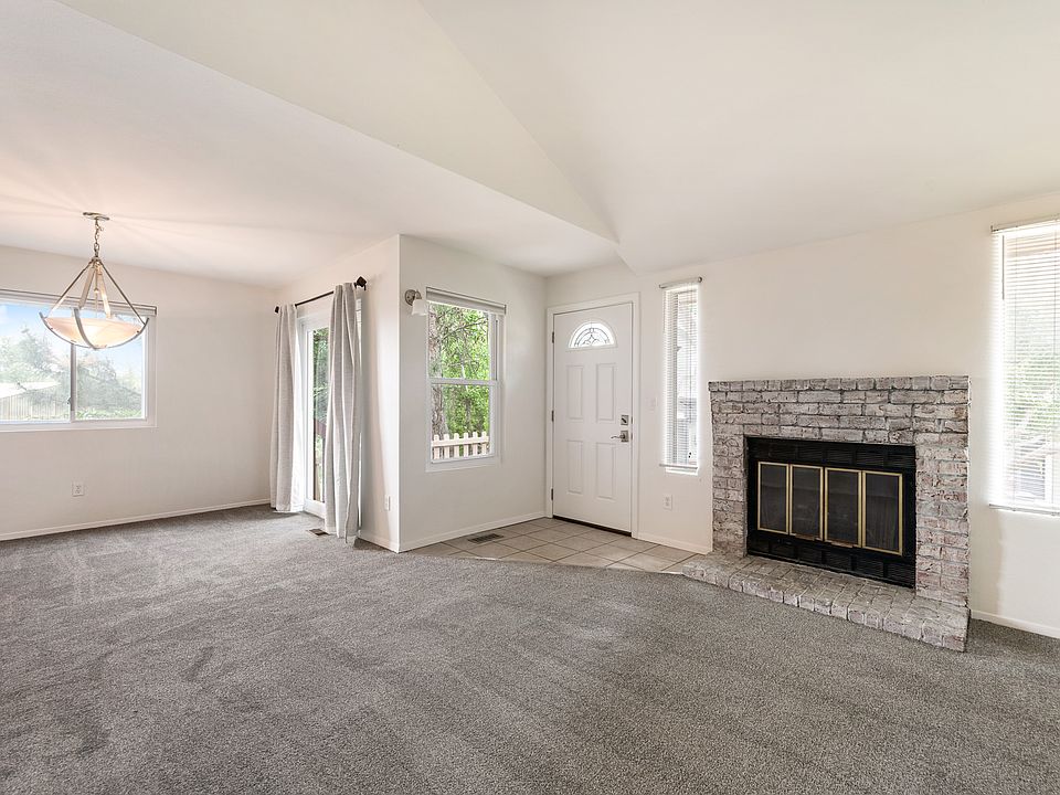 Open concept floor plan with living room and dining room. Vaulted ceilings.
