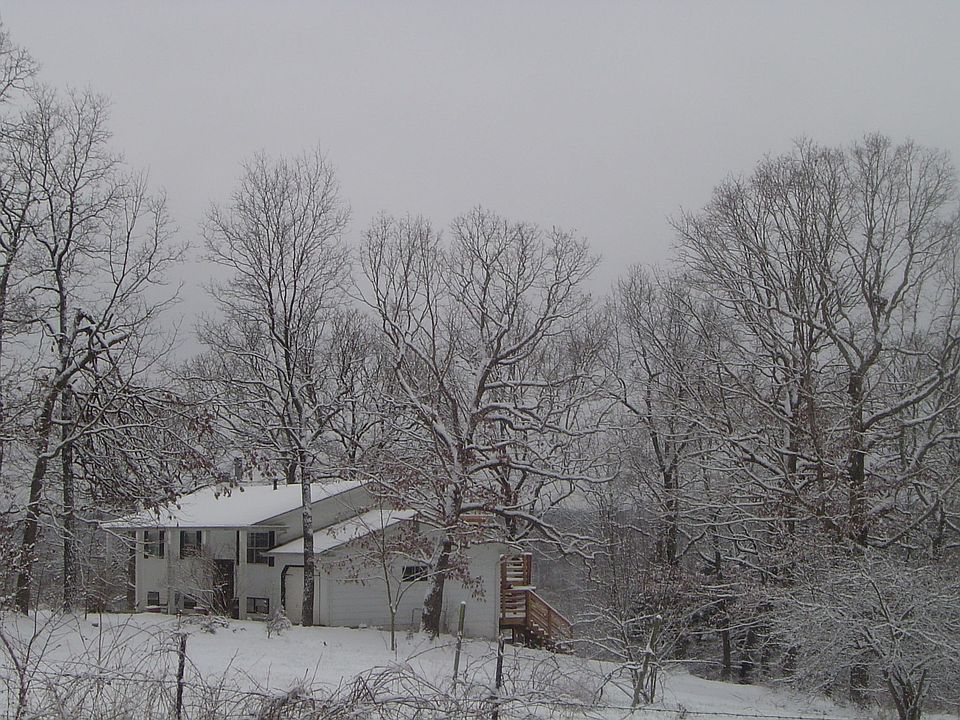 House and property under a winter blanket