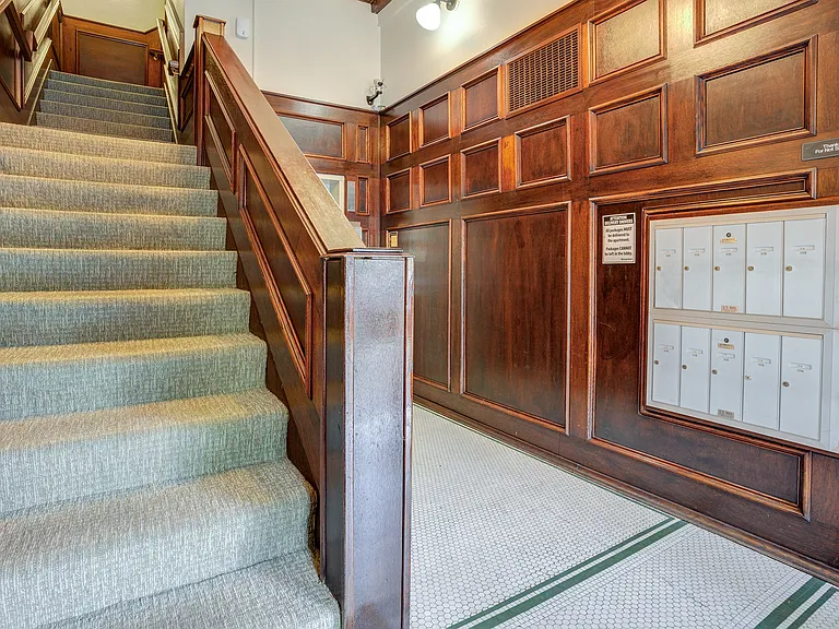 Hallway with mailboxes and staircase