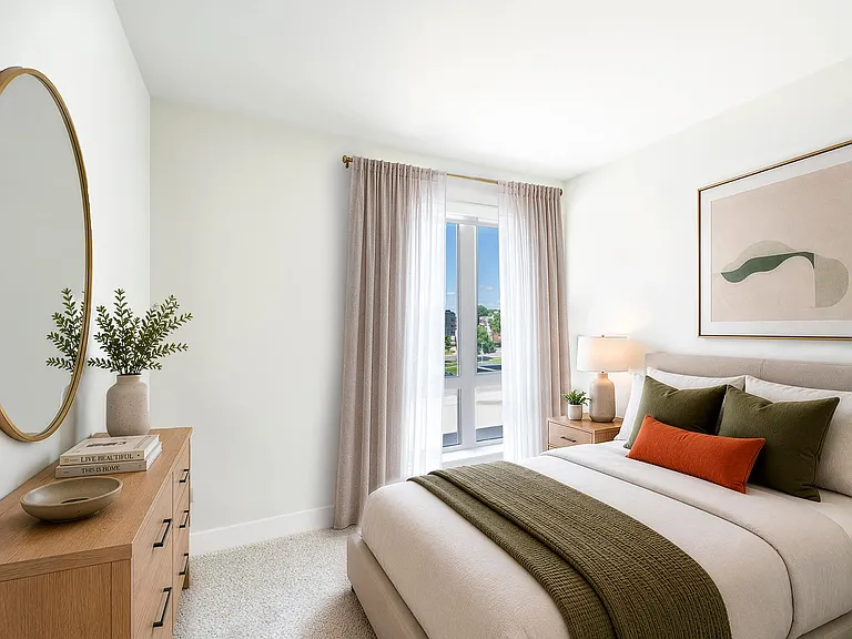 Primary bedroom with expansive windows that bring in natural light and DC views.