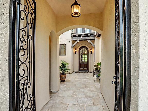 Ornate iron gates welcome you into the front courtyard
