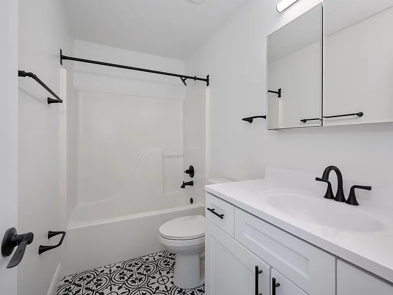 Step into elegance with this modern bathroom design, featuring stylish black accents. Step into elegance with this modern bathroom design, featuring stylish black accents.